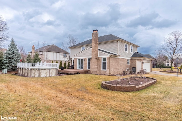 back of house with brick siding, a covered pool, a chimney, and a lawn