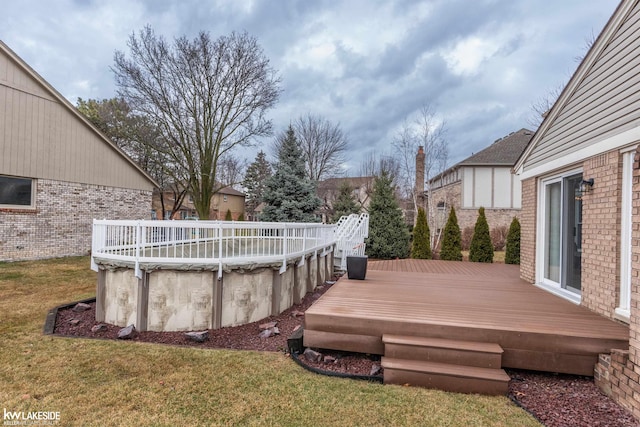 wooden deck with a covered pool and a yard