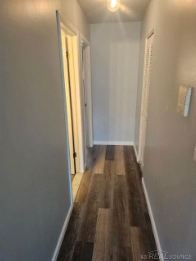 hall with wood finished floors and baseboards