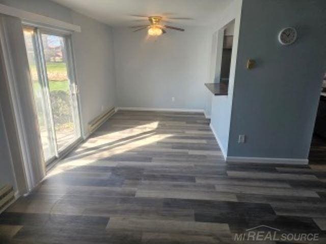 living room featuring a ceiling fan, baseboards, and wood finished floors