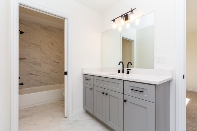 bathroom with marble finish floor,  shower combination, vanity, and baseboards