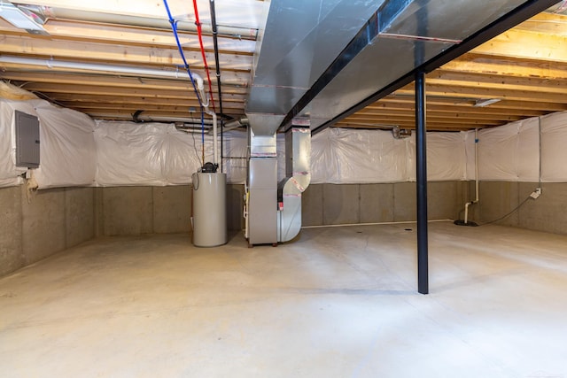 unfinished basement with electric panel, water heater, and heating unit