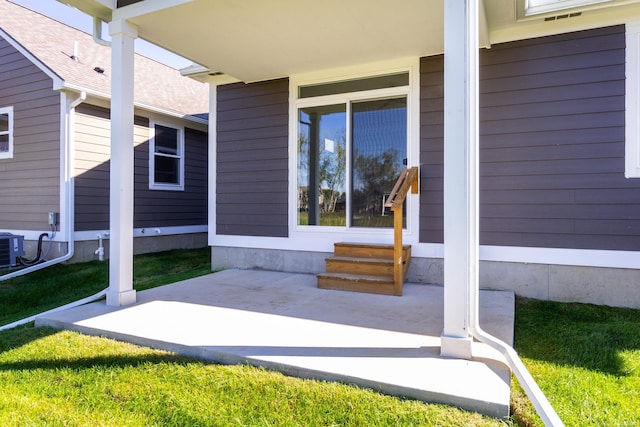 view of exterior entry with a shingled roof