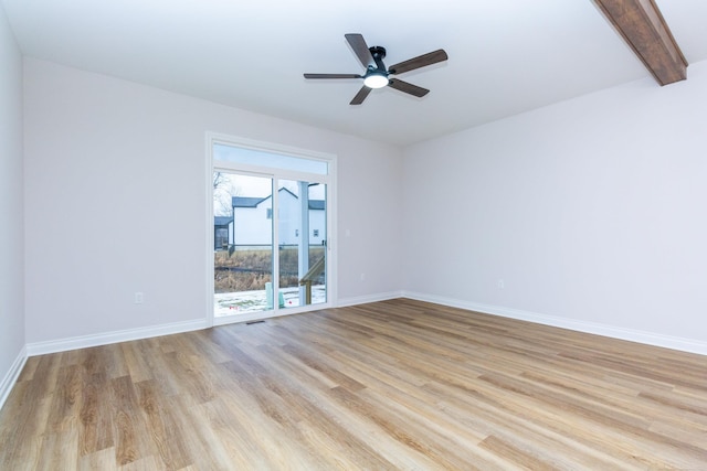 empty room with beamed ceiling, light wood-type flooring, a ceiling fan, and baseboards