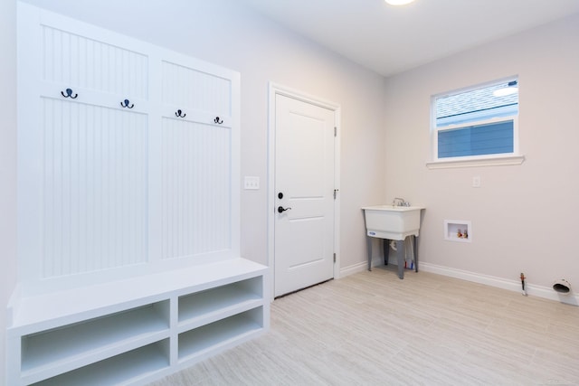 mudroom featuring light wood-style floors and baseboards