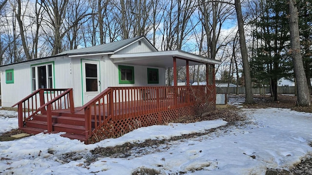 view of front of home featuring a carport and fence