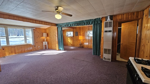 interior space featuring electric panel, wooden walls, and a ceiling fan