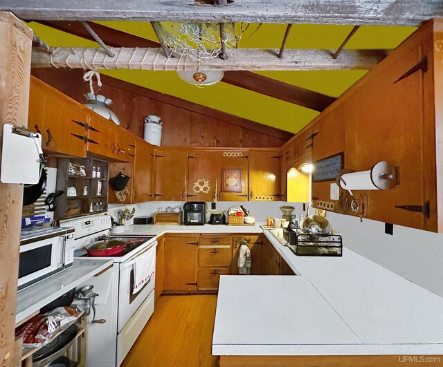 kitchen featuring white appliances, lofted ceiling, light wood-style flooring, brown cabinets, and light countertops