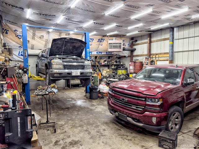 garage featuring metal wall and a workshop area