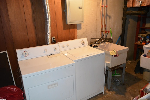 laundry area featuring laundry area, washing machine and dryer, and electric panel