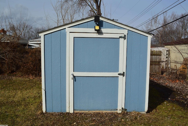 view of shed with fence