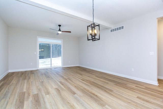 unfurnished room with light wood-style floors, beam ceiling, visible vents, and baseboards