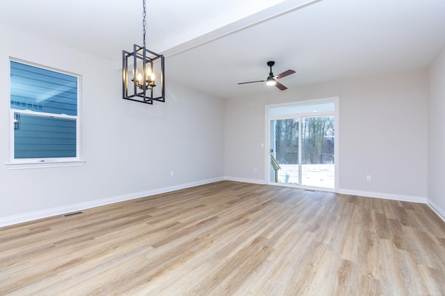 unfurnished room with beam ceiling, visible vents, light wood-style floors, ceiling fan, and baseboards