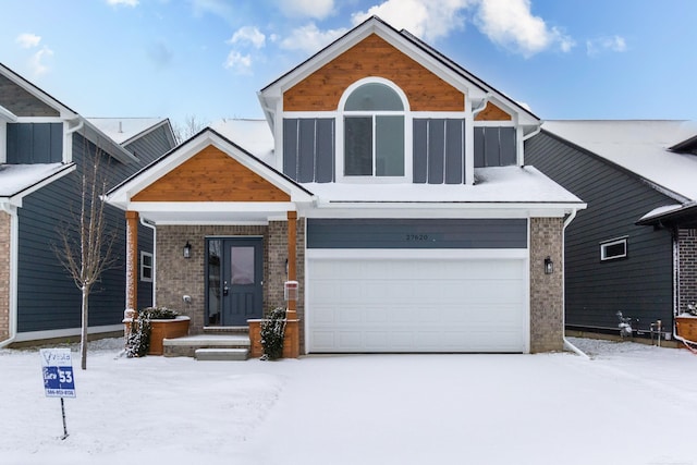 view of front of house featuring a garage and brick siding