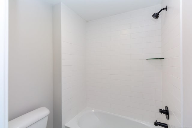 bathroom featuring shower / washtub combination and toilet