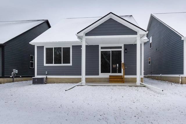 snow covered house with cooling unit