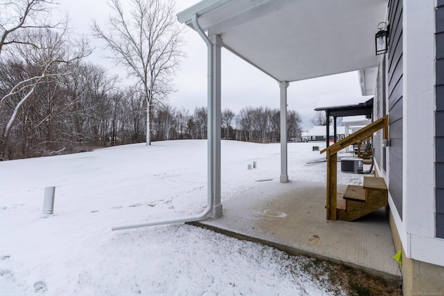 snowy yard with central AC