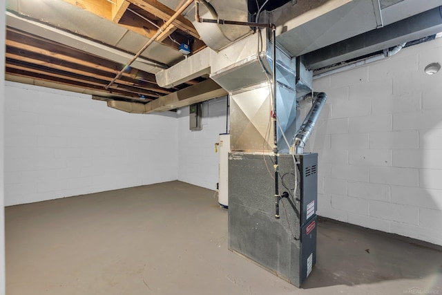 unfinished below grade area with gas water heater, electric panel, and heating unit