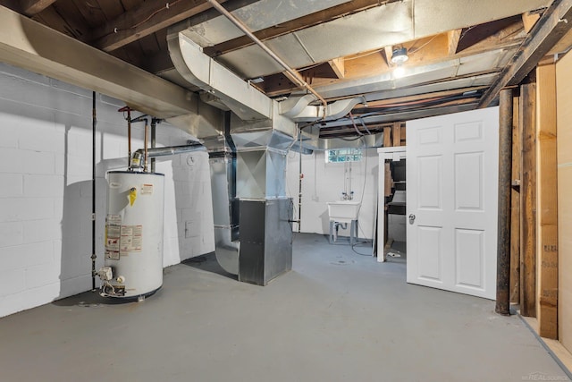 basement featuring gas water heater, a sink, and heating unit