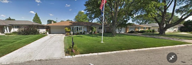 single story home featuring a garage, driveway, and a front lawn