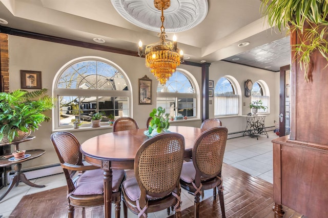 tiled dining area featuring a tray ceiling, plenty of natural light, and an inviting chandelier