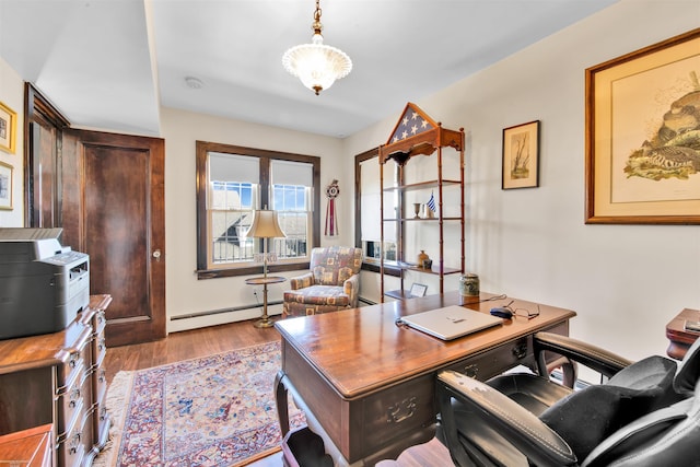 home office with a baseboard radiator and wood finished floors