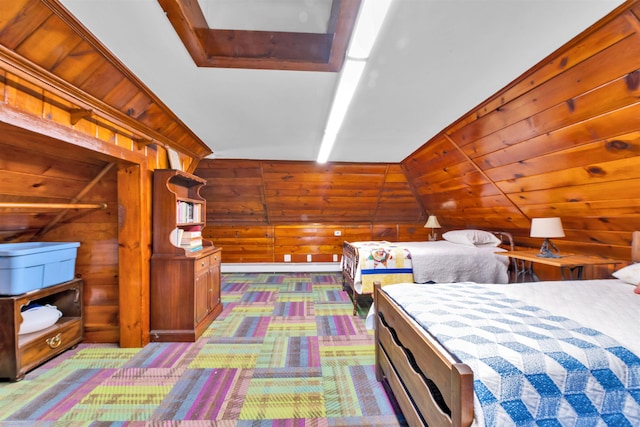 bedroom featuring lofted ceiling, wood walls, and carpet