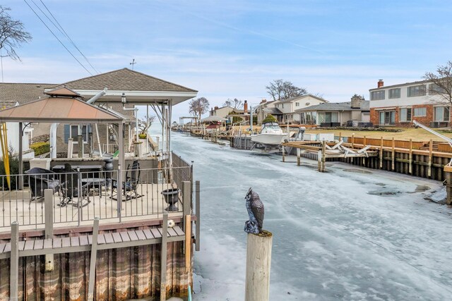 dock area with a gazebo and a residential view