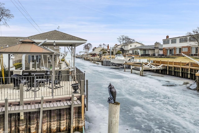 view of dock with a gazebo and a residential view