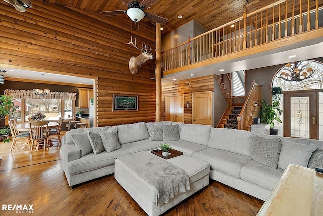 living room with high vaulted ceiling, hardwood / wood-style floors, stairway, and wood ceiling