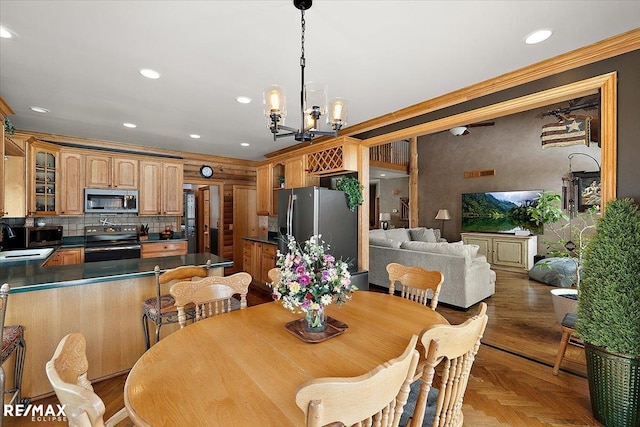 dining space featuring recessed lighting and an inviting chandelier