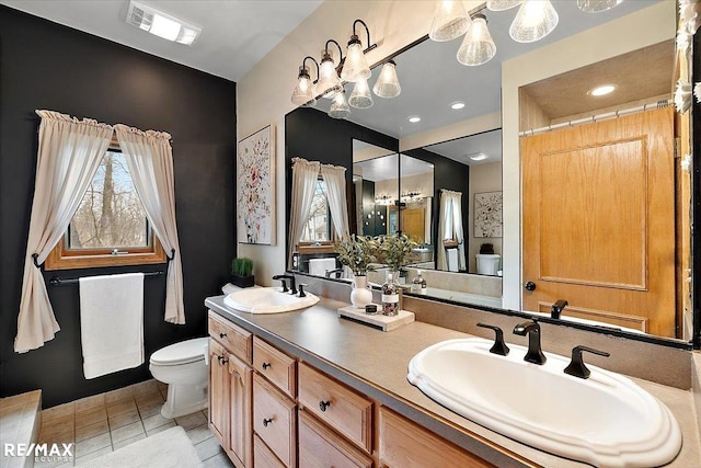 bathroom featuring tile patterned flooring, visible vents, a sink, and toilet