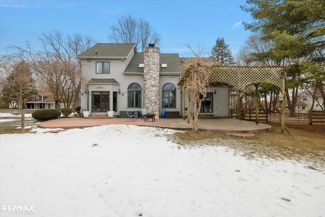 back of house featuring fence, a chimney, and a patio