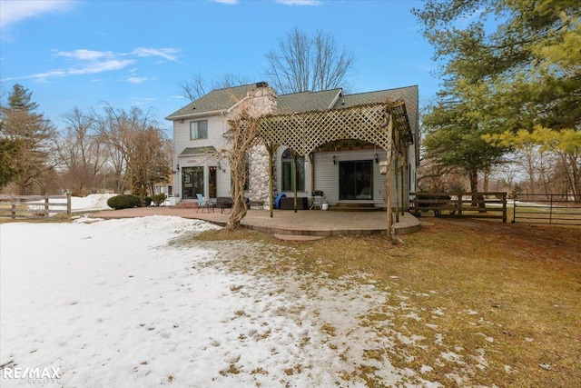 back of property with a patio area and fence