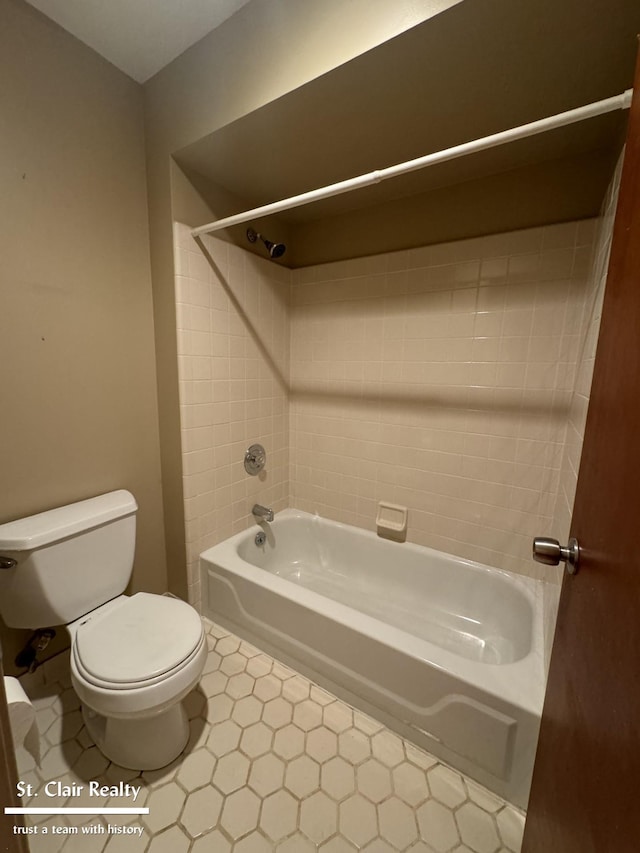 full bathroom with shower / washtub combination, toilet, and tile patterned floors