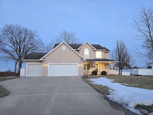 traditional home featuring a garage, fence, a porch, and concrete driveway