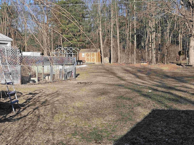 view of yard featuring an outbuilding and a shed