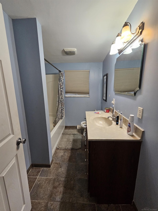 full bathroom featuring baseboards, shower / tub combo, toilet, and vanity