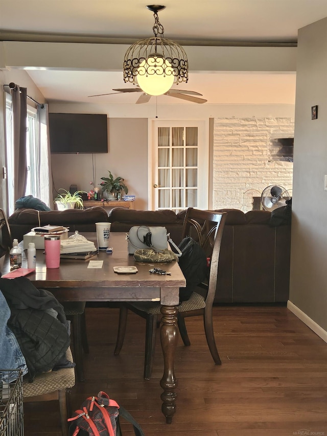 dining area with baseboards and wood finished floors