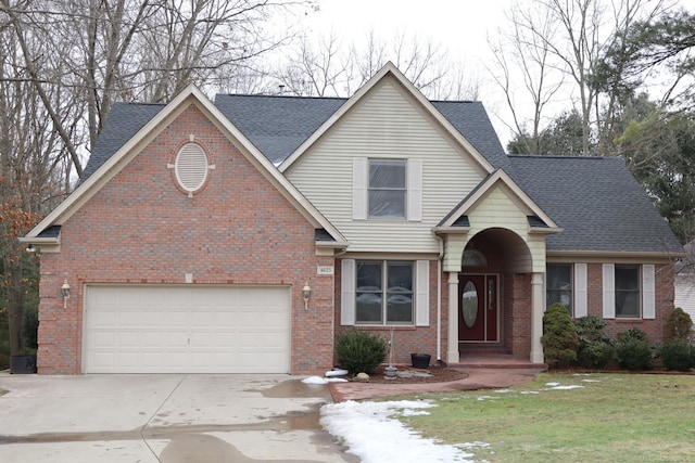 traditional-style home with brick siding, driveway, a front lawn, and roof with shingles