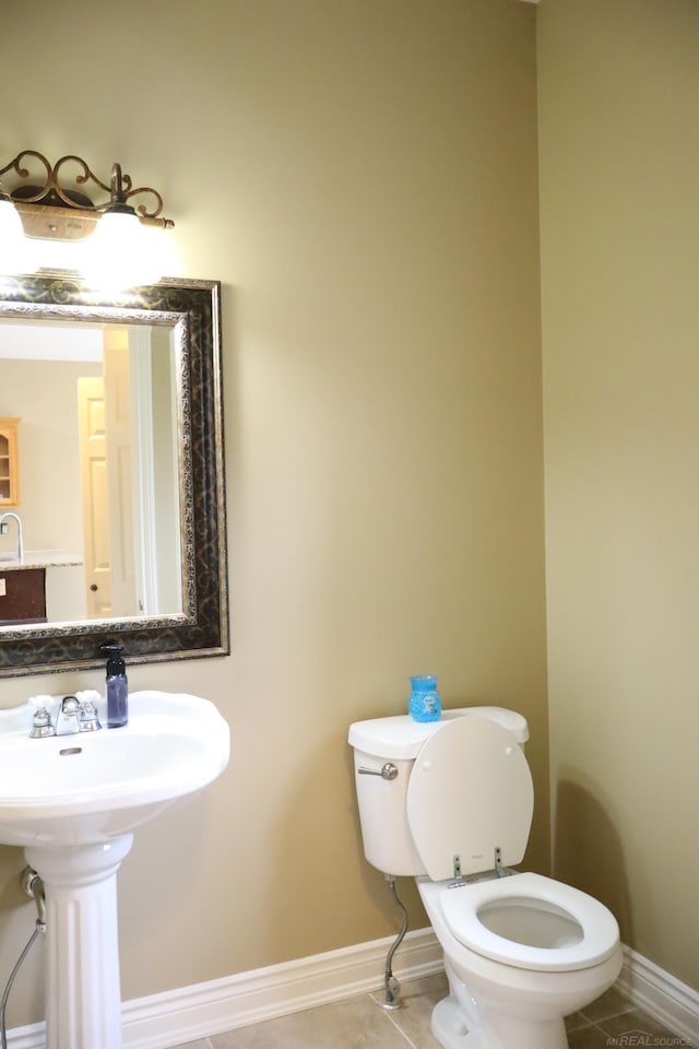 bathroom featuring baseboards, toilet, and tile patterned floors