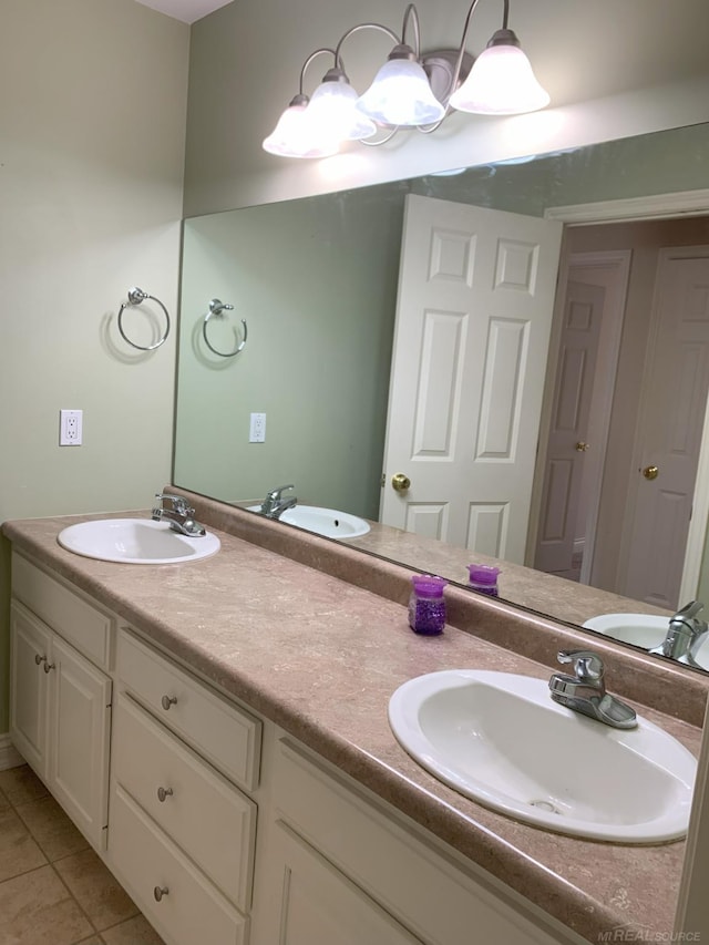 bathroom featuring double vanity, a sink, and tile patterned floors