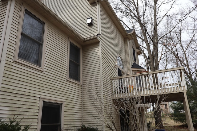 view of side of home featuring a wooden deck