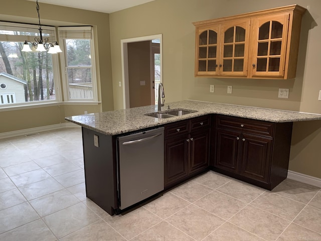 kitchen featuring light stone counters, a notable chandelier, glass insert cabinets, a sink, and dishwasher