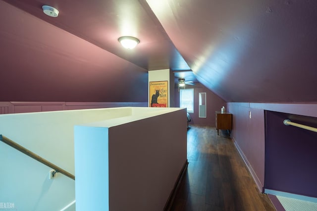 additional living space with dark wood-style floors and vaulted ceiling