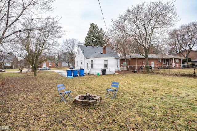 view of yard with a fire pit and fence