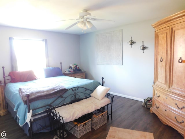 bedroom with dark wood-type flooring, a ceiling fan, and baseboards