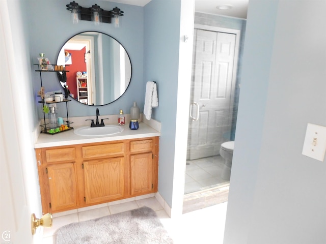 full bathroom featuring toilet, a shower stall, vanity, and tile patterned floors