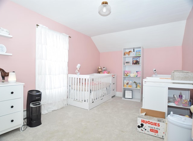 bedroom featuring a nursery area, carpet flooring, and lofted ceiling