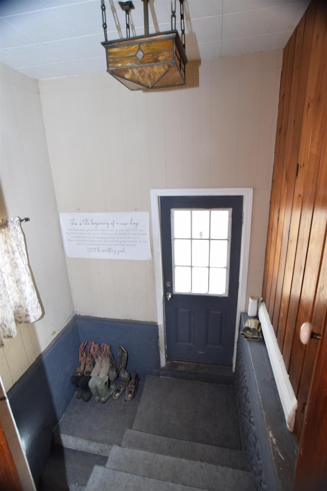 entryway featuring wooden walls